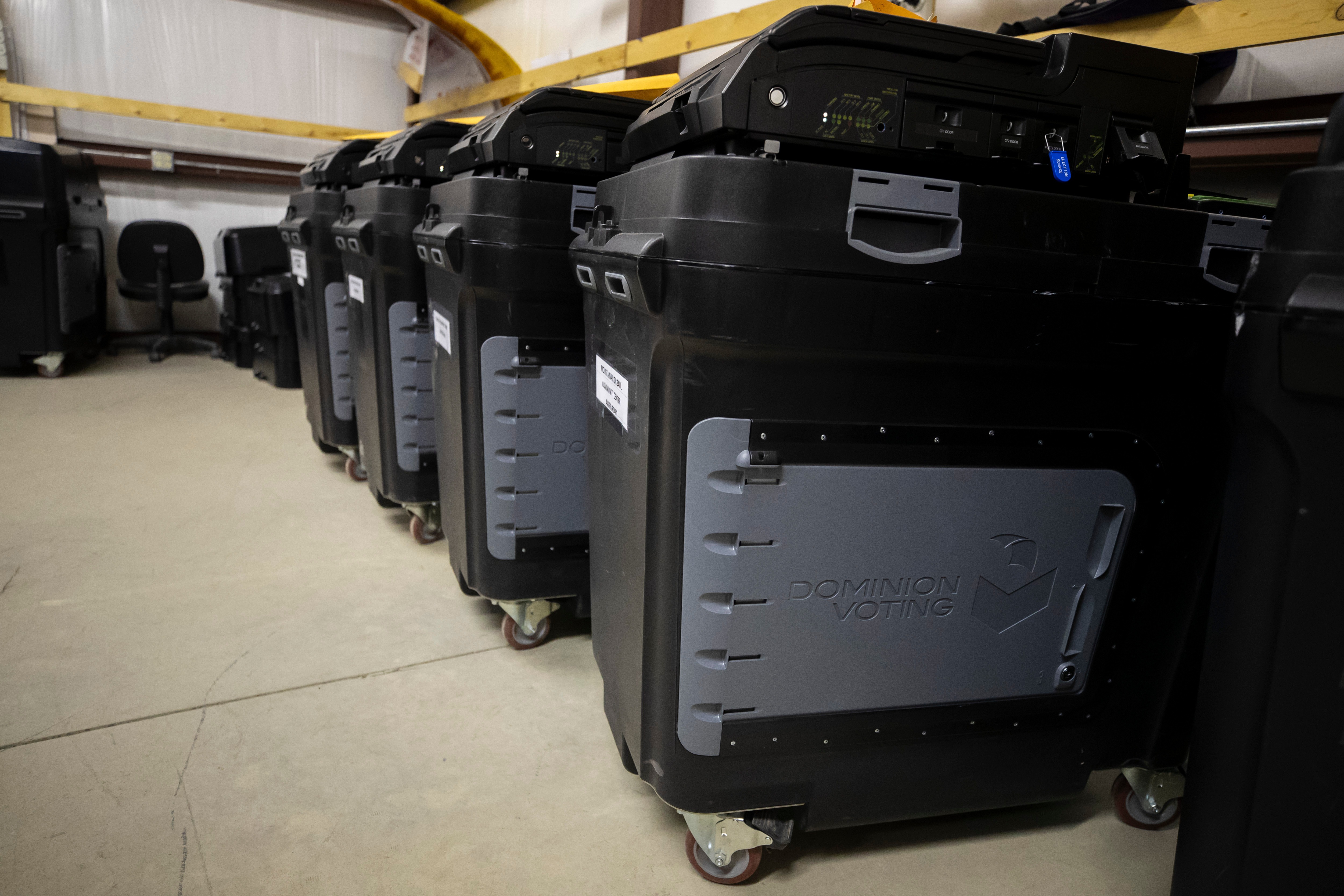 Dominion Voting Systems ballot-counting machines are lined up at a Torrance County warehouse during a testing of election equipment in Estancia, N.M., on Sept. 29, 2022.